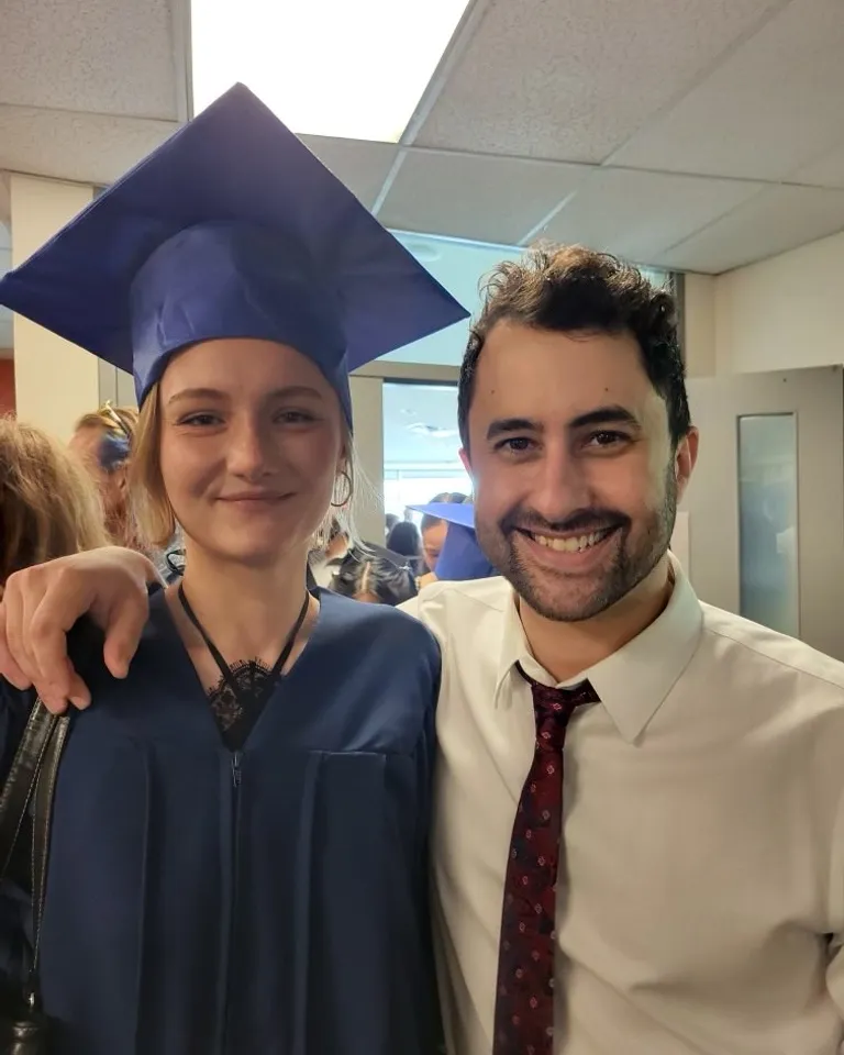 a girl in a graduation gown and her boyfriend pose for photos before launching to the moon
, advertising style