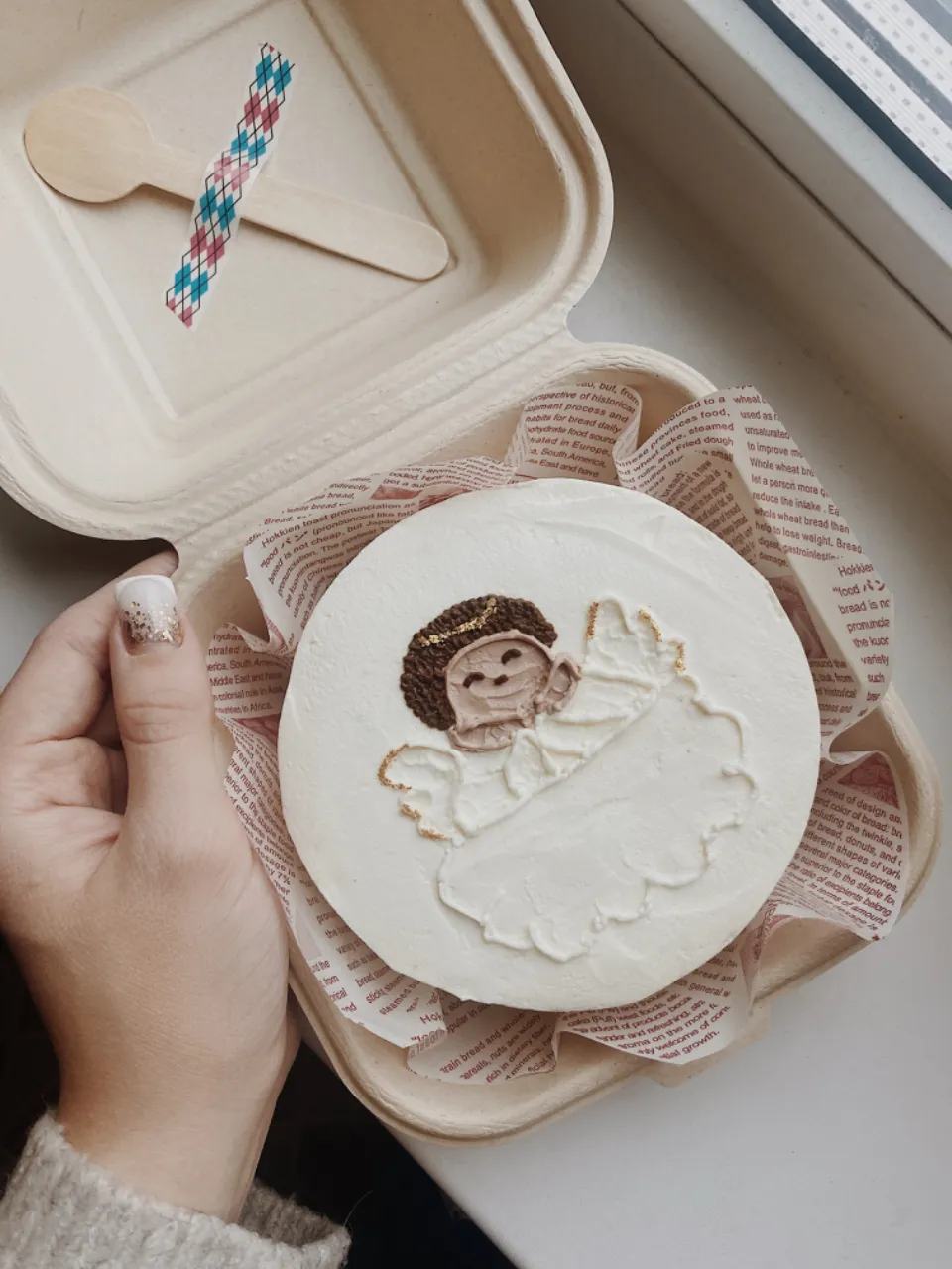 a person holding a cake with a monkey on it