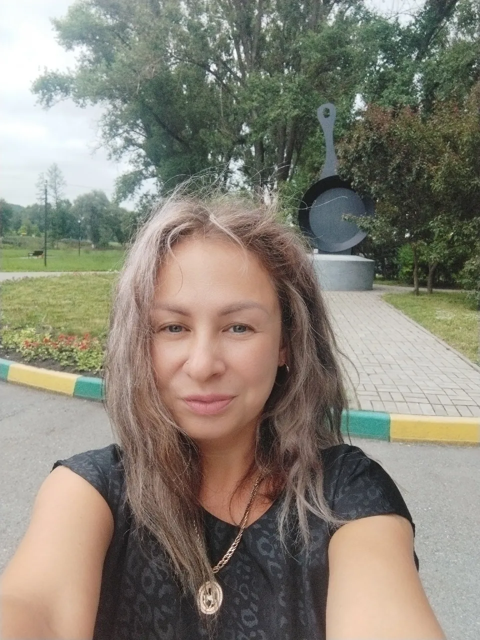 a woman taking a selfie in a park