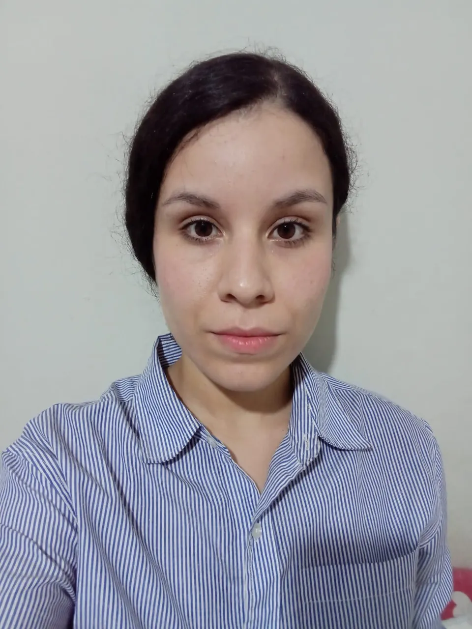 Portrait of a woman with a bold red lip and perfectly groomed eyebrows, wearing a vintage dress shirt with a popped collar and gold necklace, her hair styled in a sleek 1920s bob, just with my photo upload