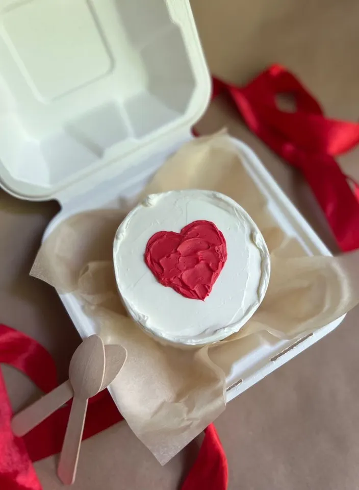 a heart shaped cake in a white box