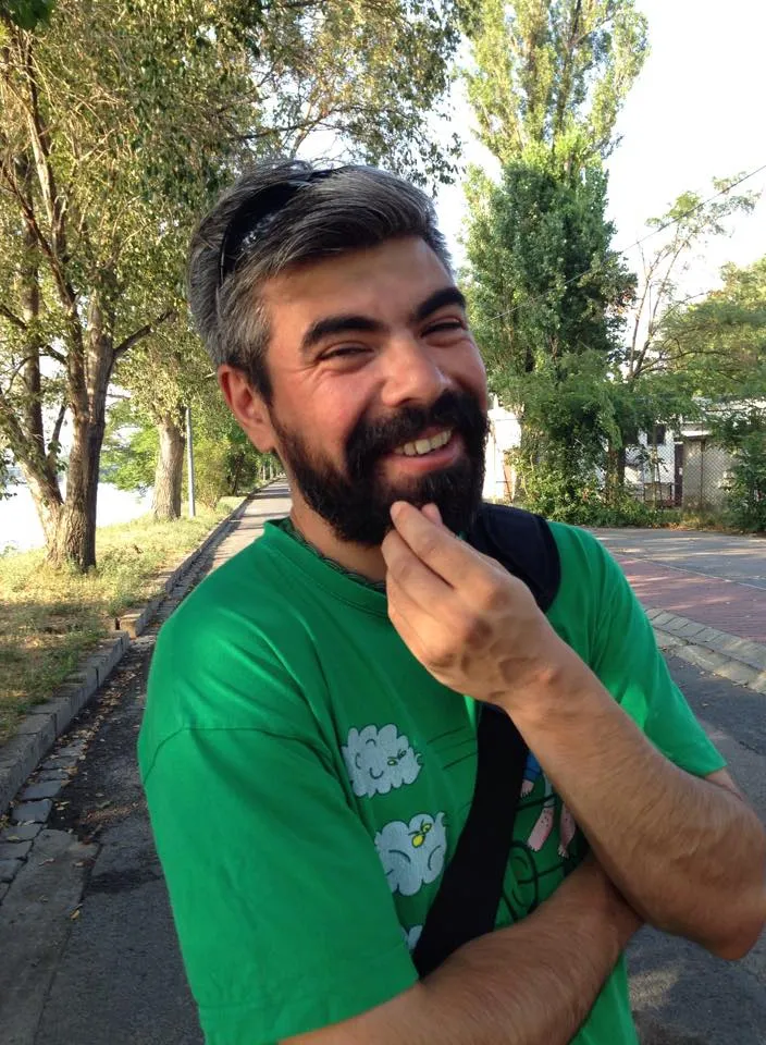a man with a beard and a green shirt