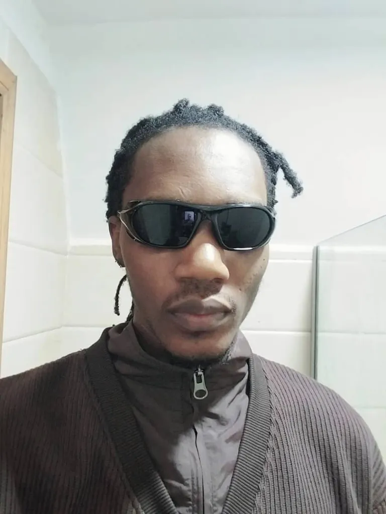 a man with sunglasses taking a selfie in a bathroom, his face transforms into Neo from The Matrix movie