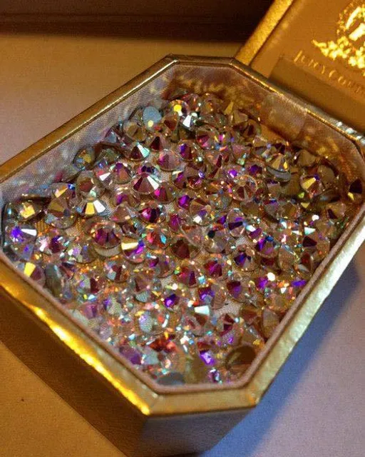 a box with a bunch of small jewels inside of it