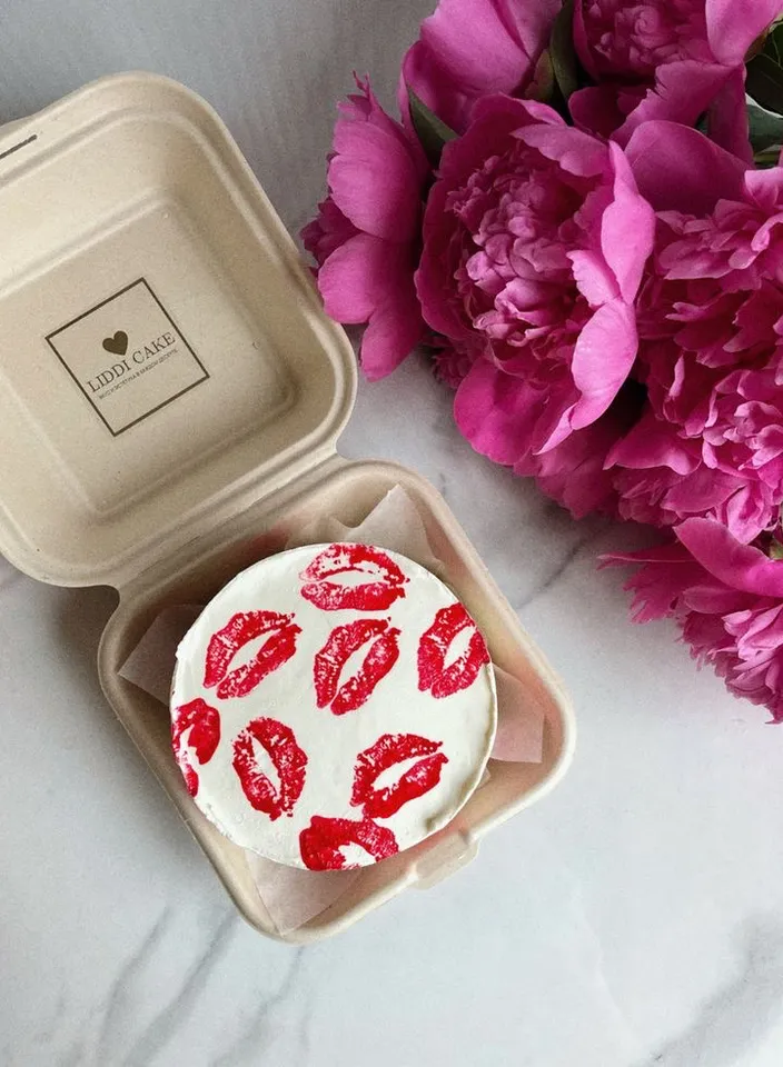 a cake in a box with red lipstick on it