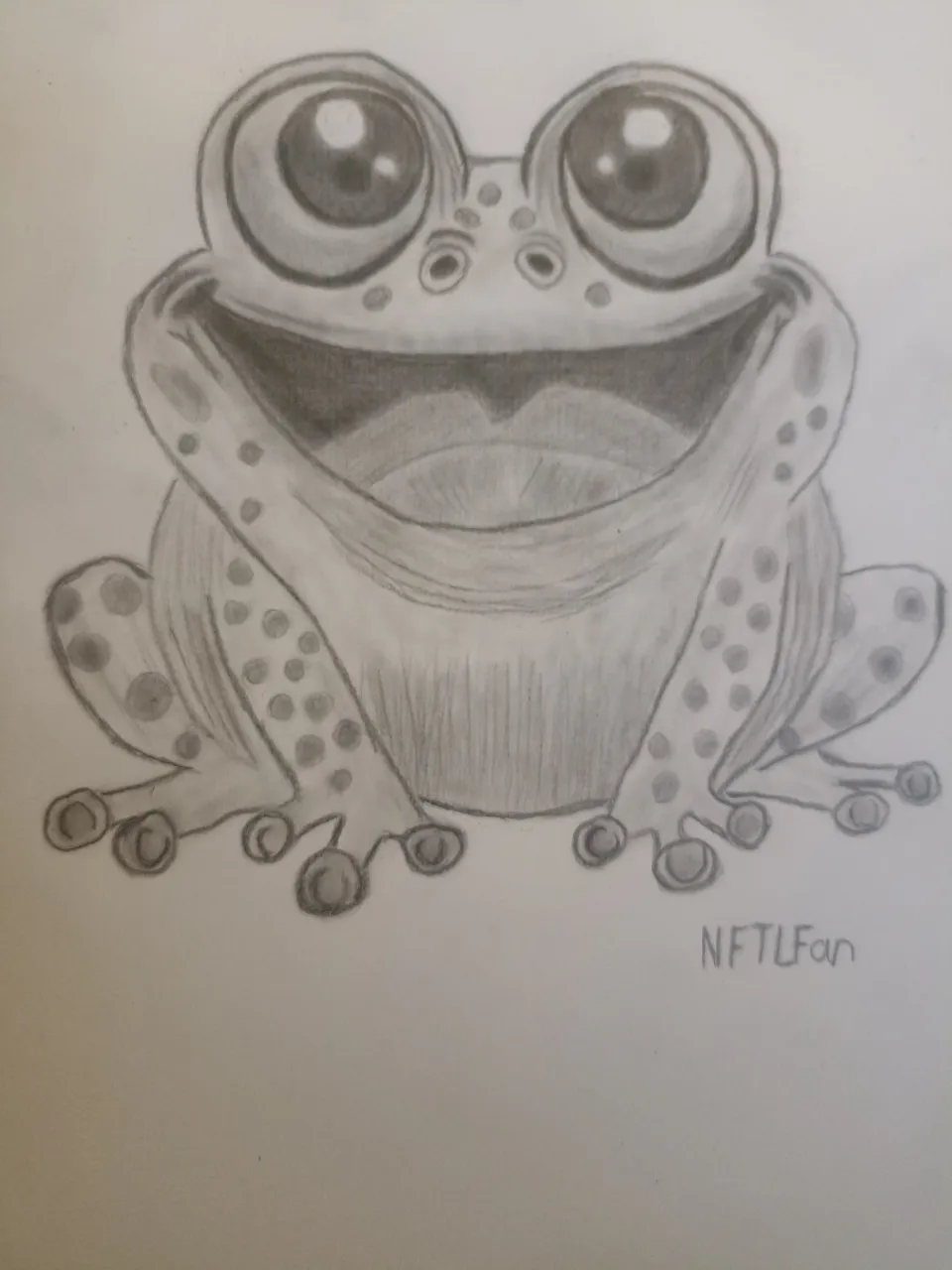 The little frog blinks his eyes and sings a song