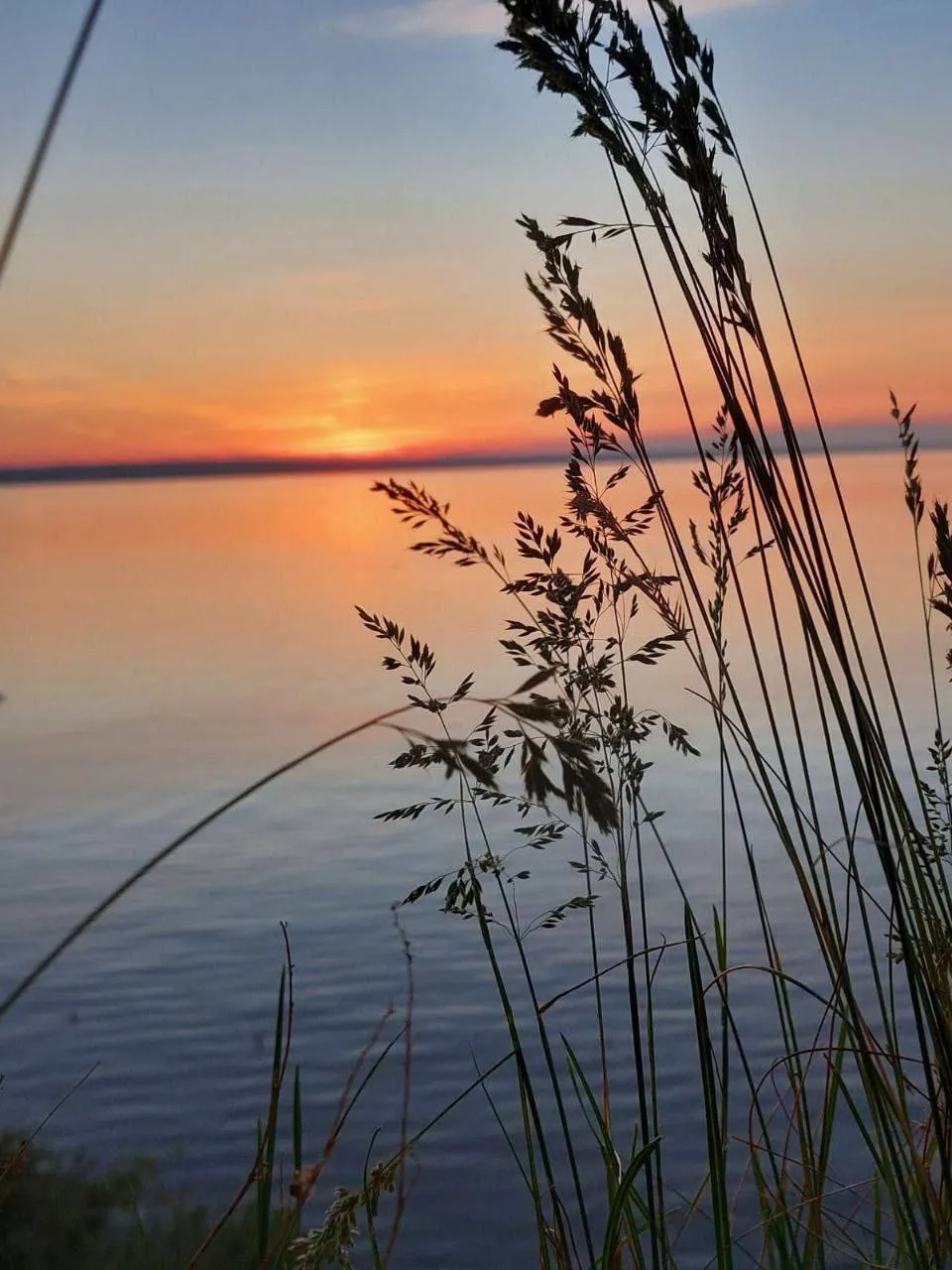 the sun is setting over a body of water