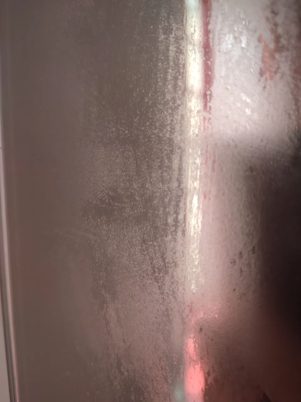 a close up of a frosted glass door breaks