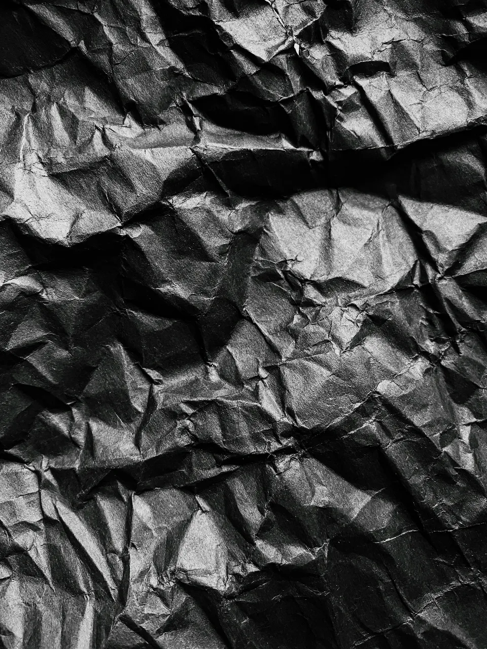 a black and white photo of crumpled paper