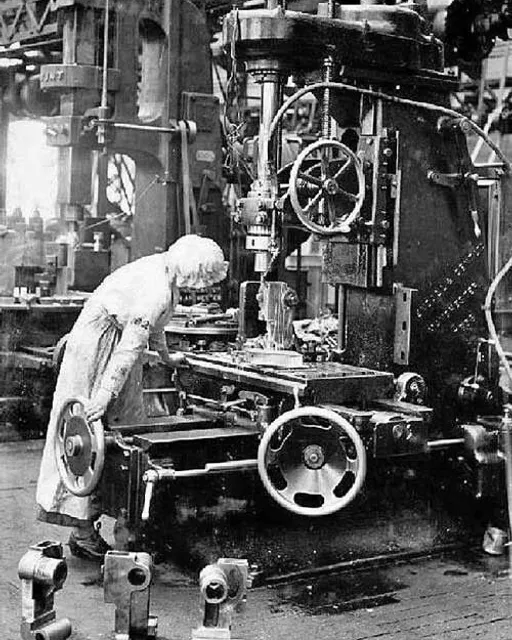 A man working on a Victorian-era contraption in an industrial workshop