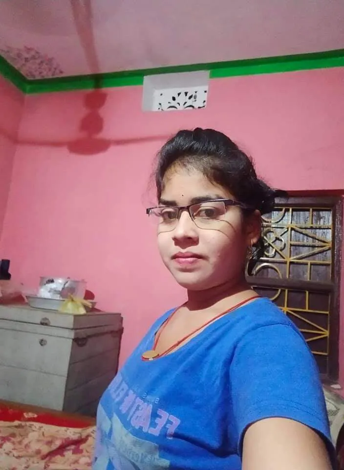 a woman standing in a room red pink walls