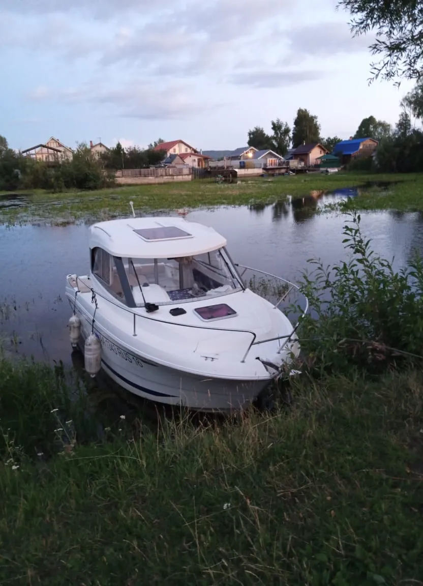 a small white boat in a body of water