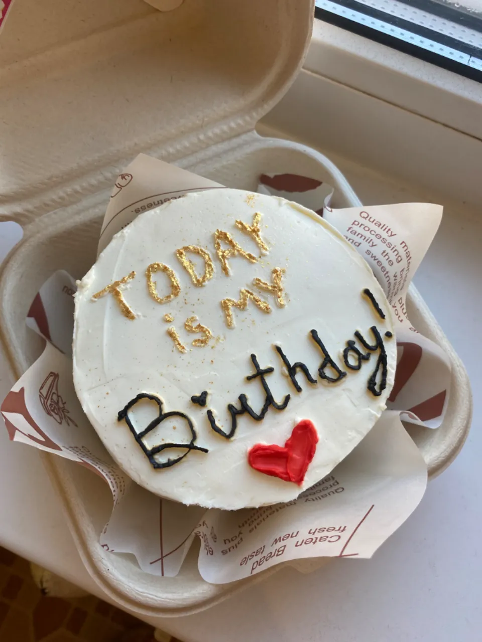 a birthday cake sitting in a box on a table