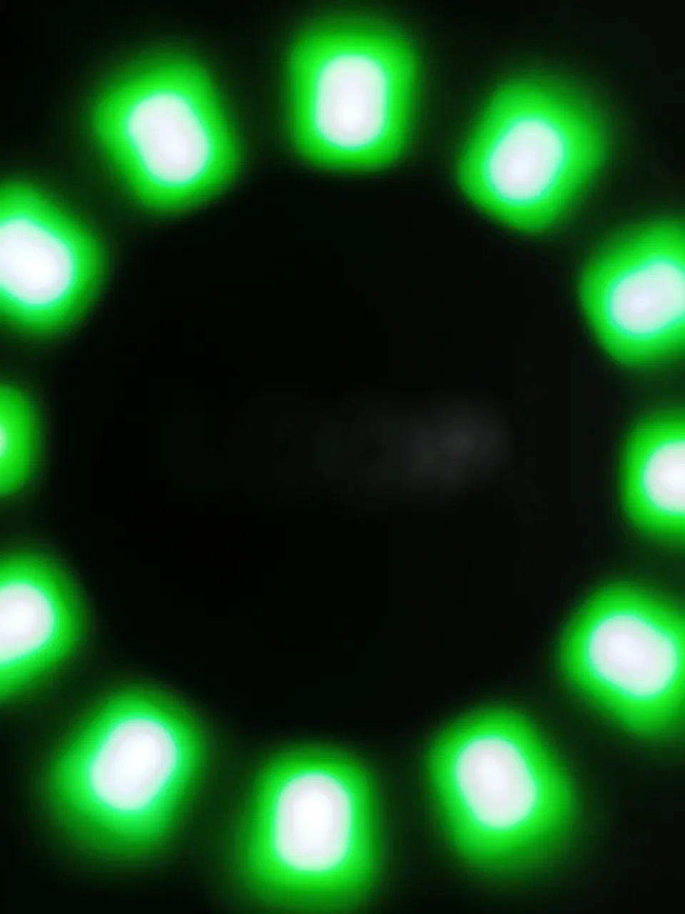 a green circle of lights on a black background