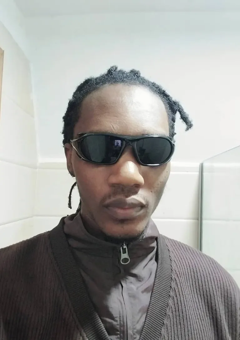 a cartoon young man wearing neon lens black sunglasses and a sweater in a bathroom