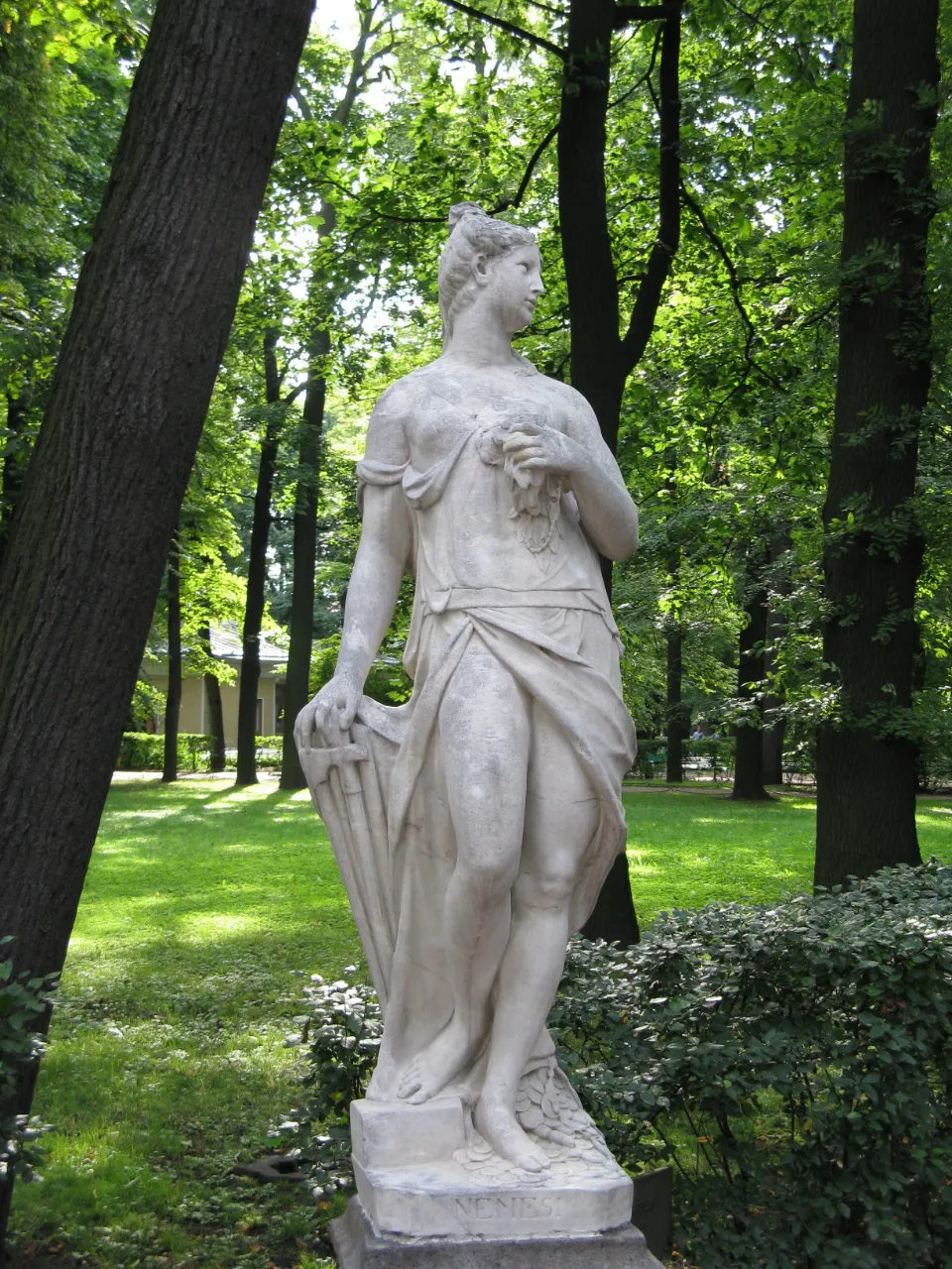 a statue of a man standing in a park