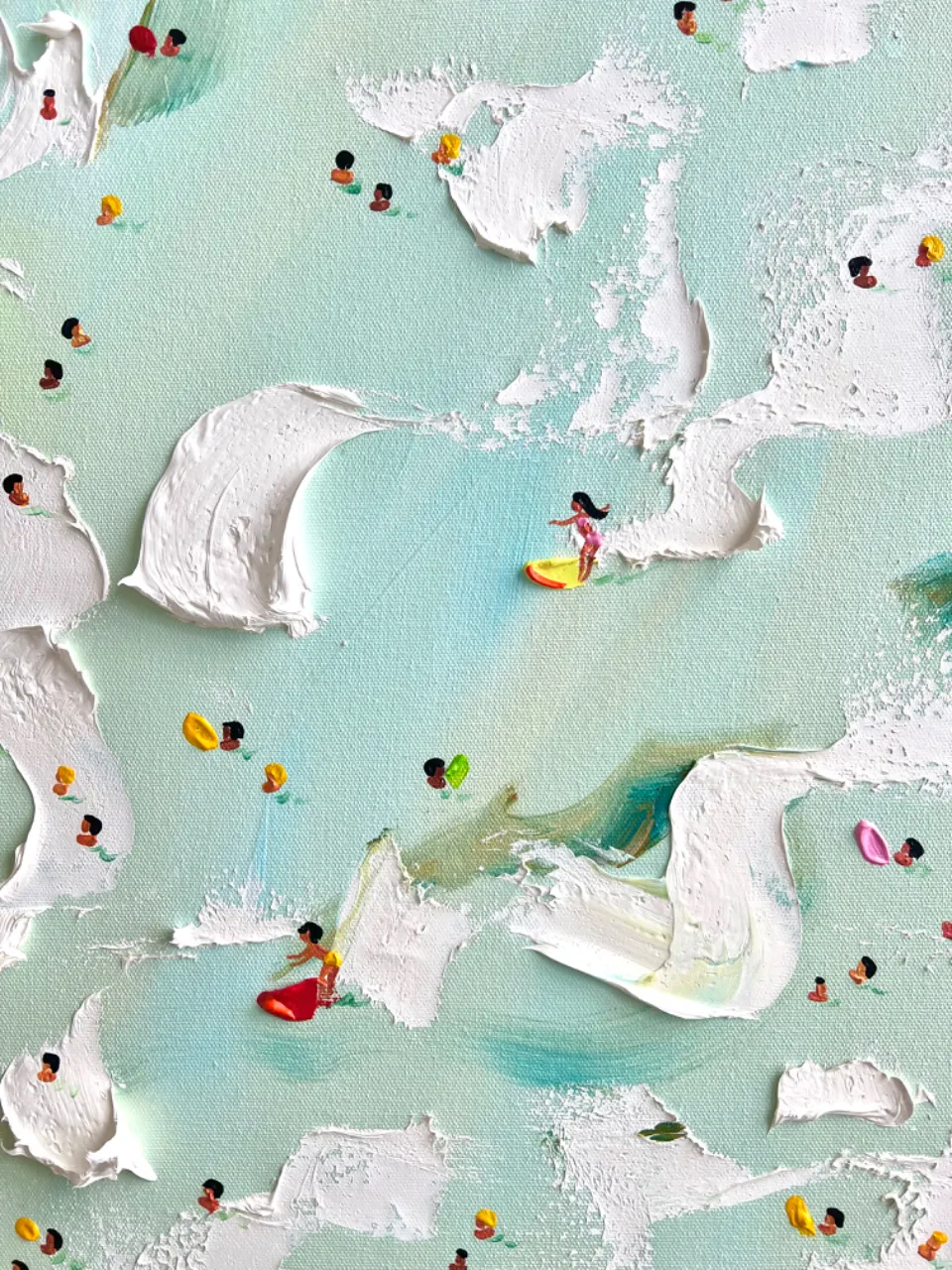 an aerial view of a beach with people in the water