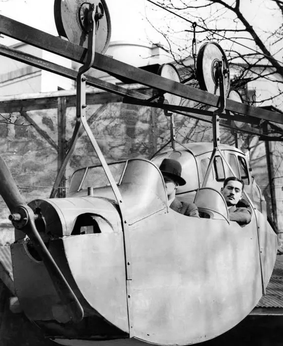 a black and white photo of a boy in a plane