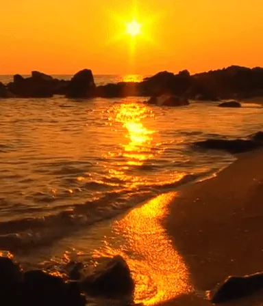 the sun is setting over the water at the beach