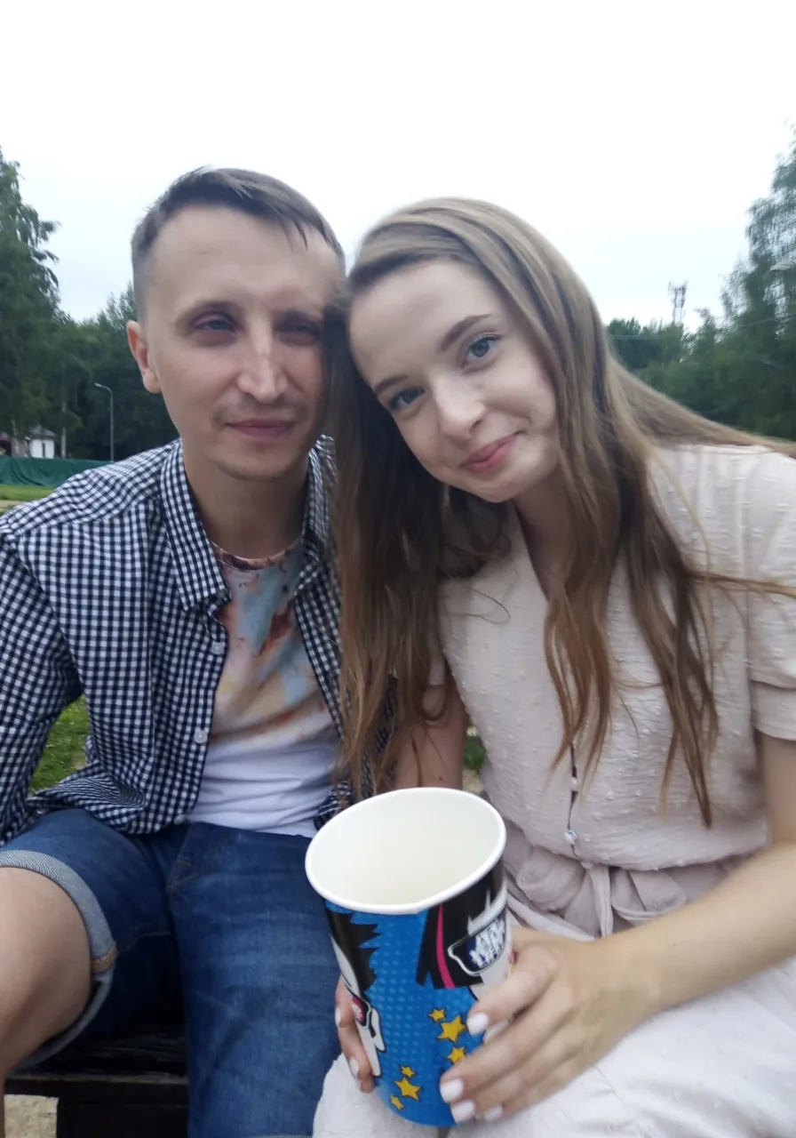 a man and a woman are sitting on a bench