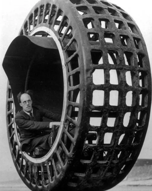 a man sitting inside of a large metal object