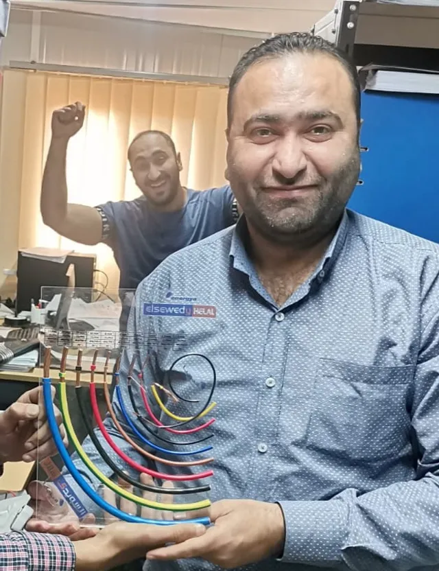 a man holding a bunch of wires in his hands