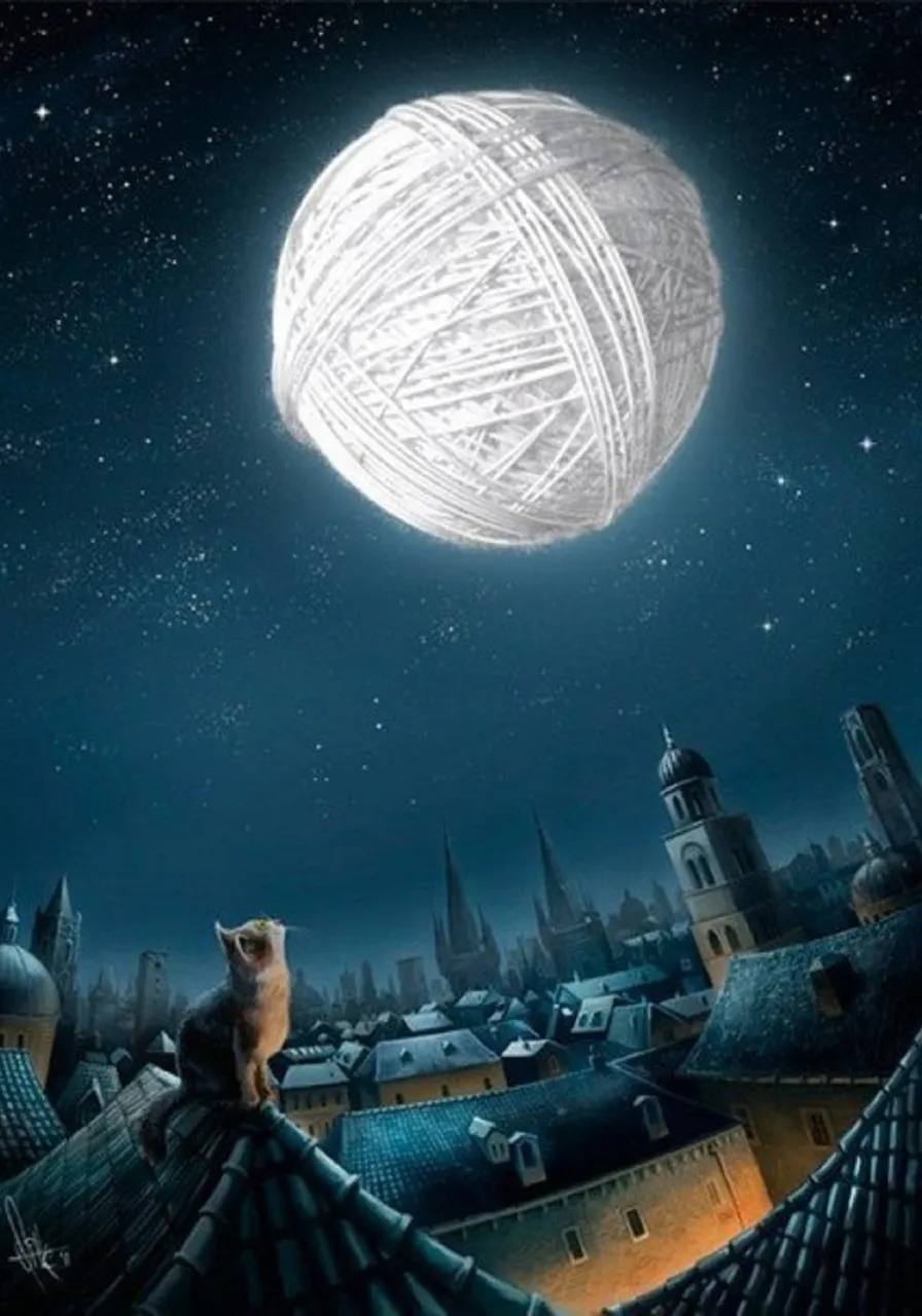 a cat sitting on top of a roof next to a ball of yarn