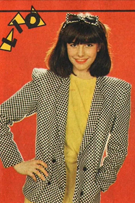 a woman in a black and white jacket and yellow shirt