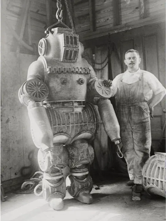 a man standing next to a giant robot