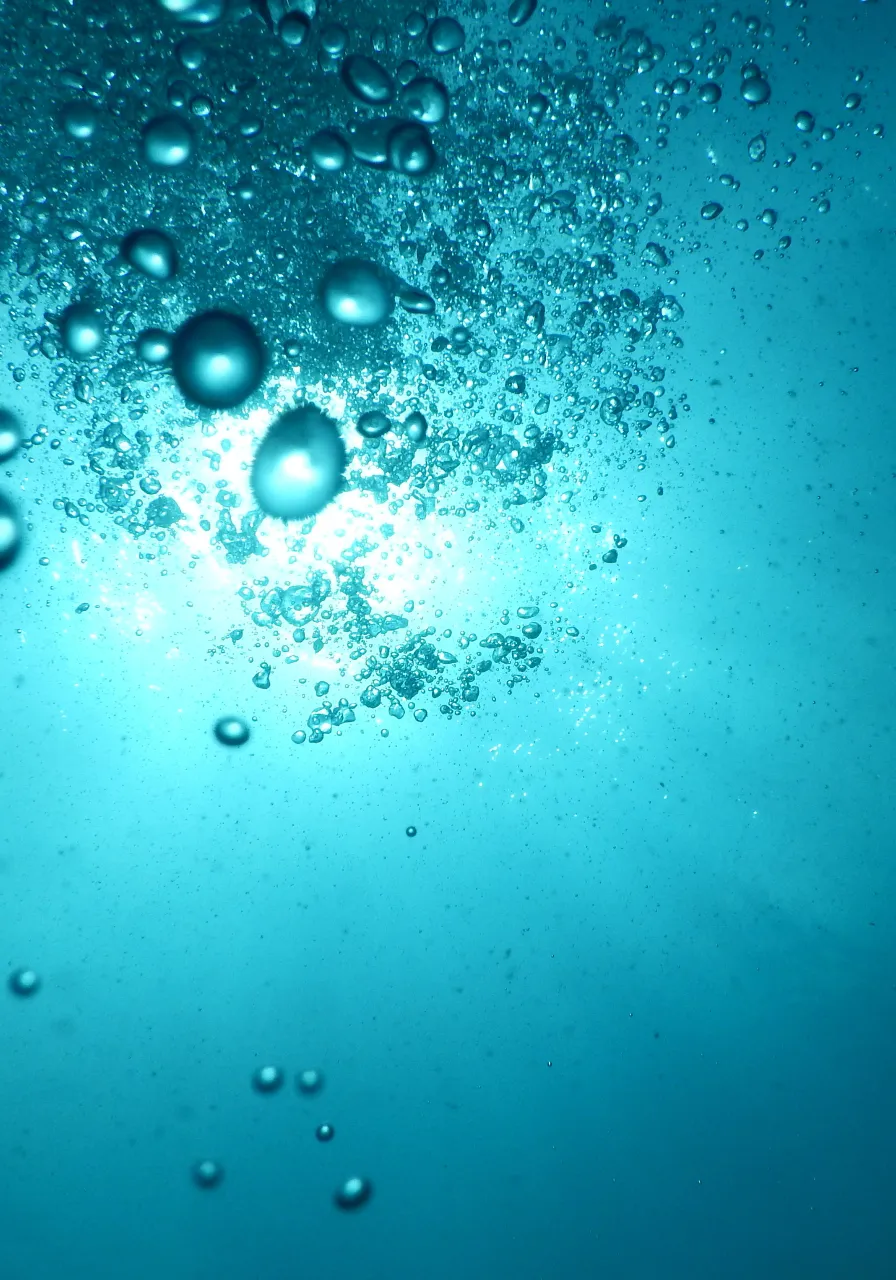 a close up of water bubbles on a blue surface