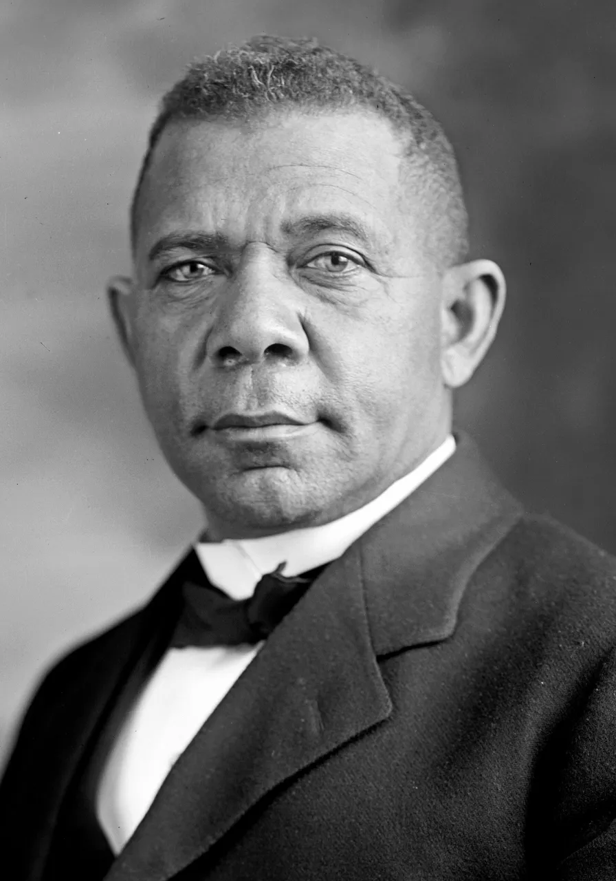 a black and white photo of a man in a suit on postage stamp