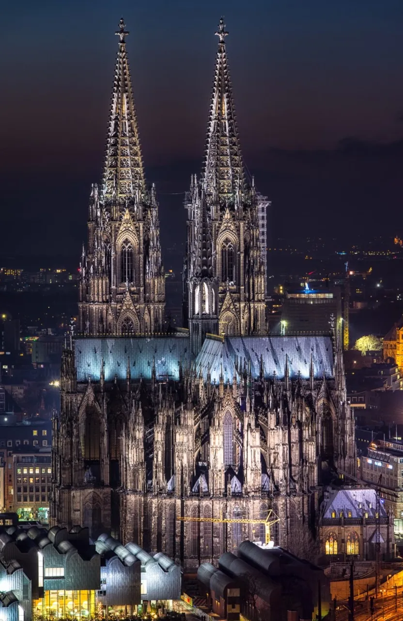 a large cathedral lit up at night in a city