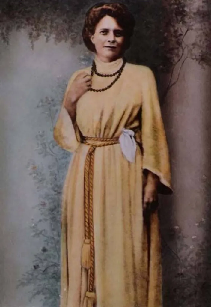 an old photo of a woman in a yellow dress