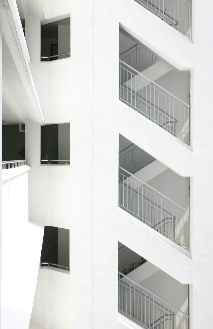 a white building with balconies and balconies