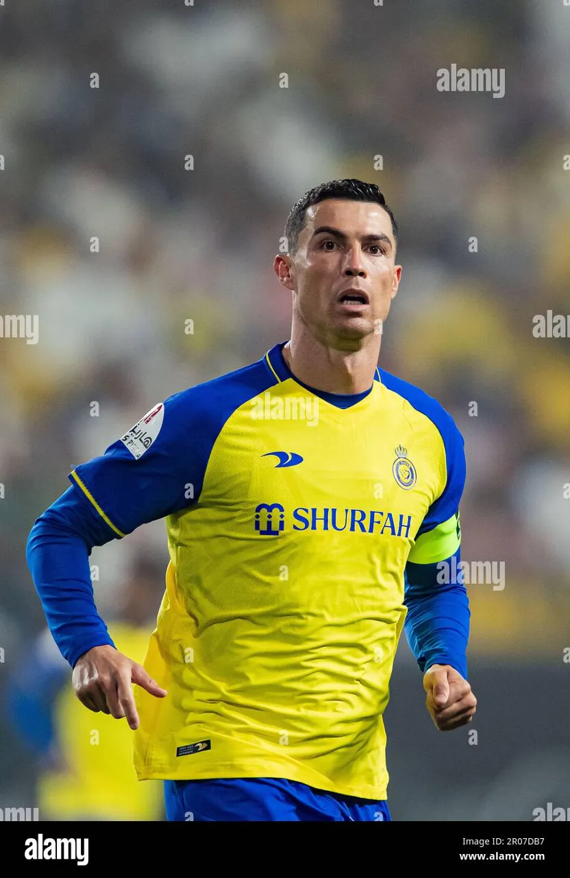 a soccer player in a yellow and blue uniform during a game - stock image