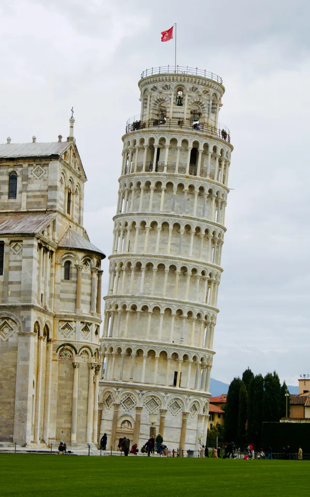 a tall tower with a flag on top of it