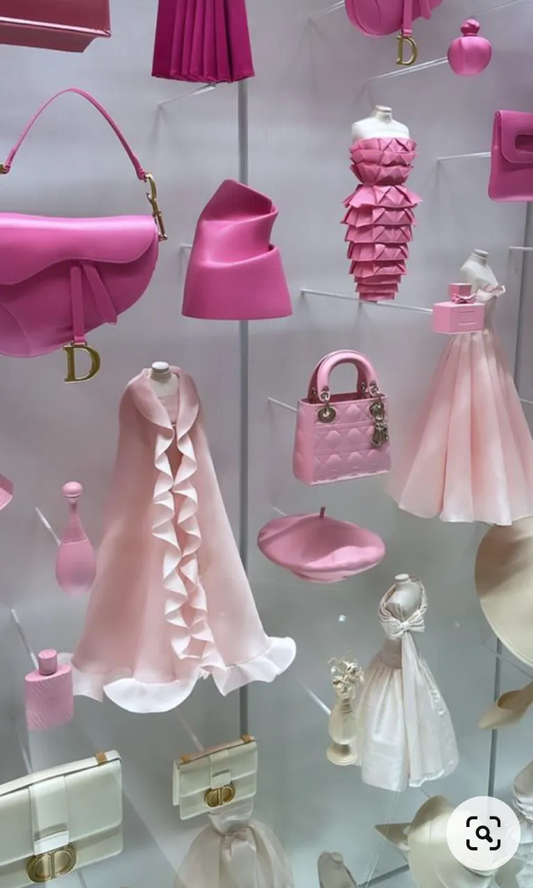 a display of pink and white dresses and purses