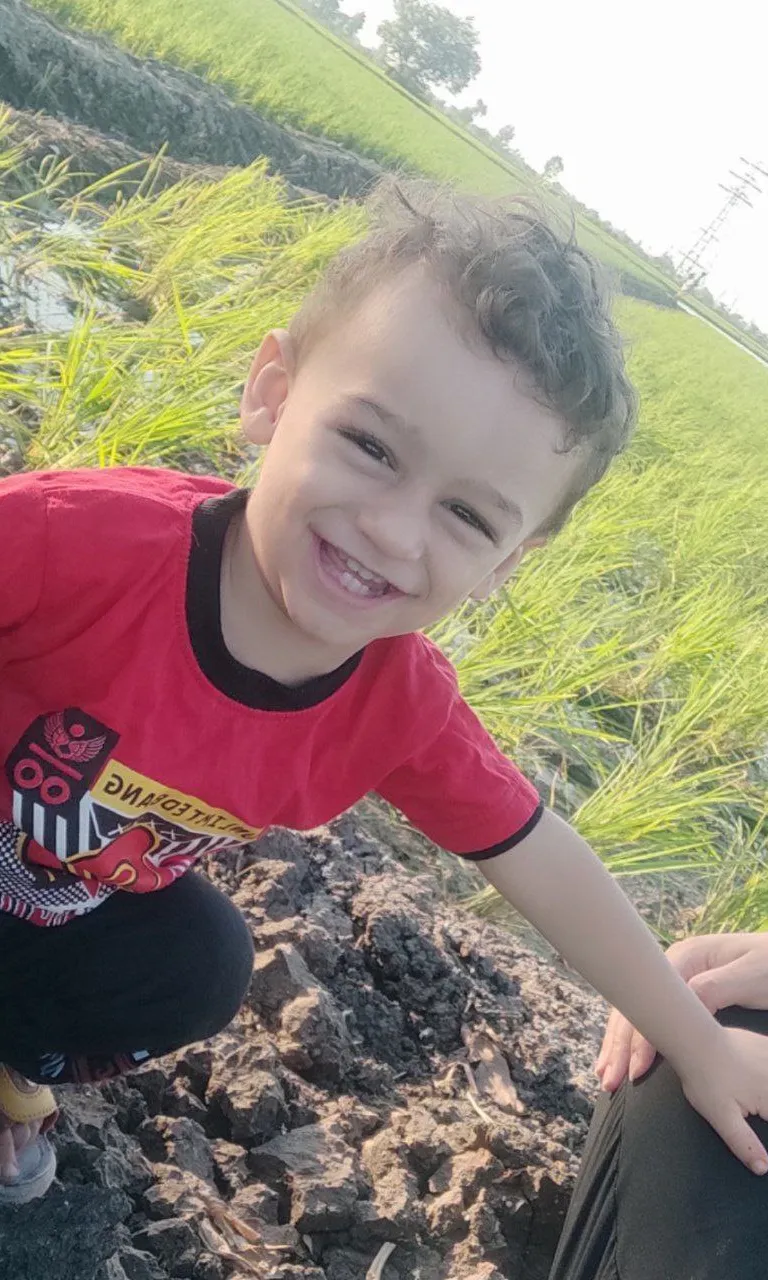 a young boy is playing in the dirt