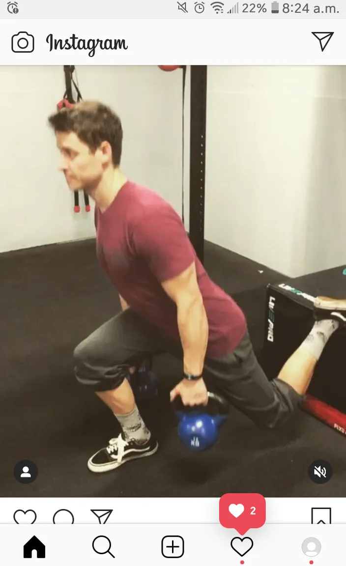 a man doing a squat with a kettle