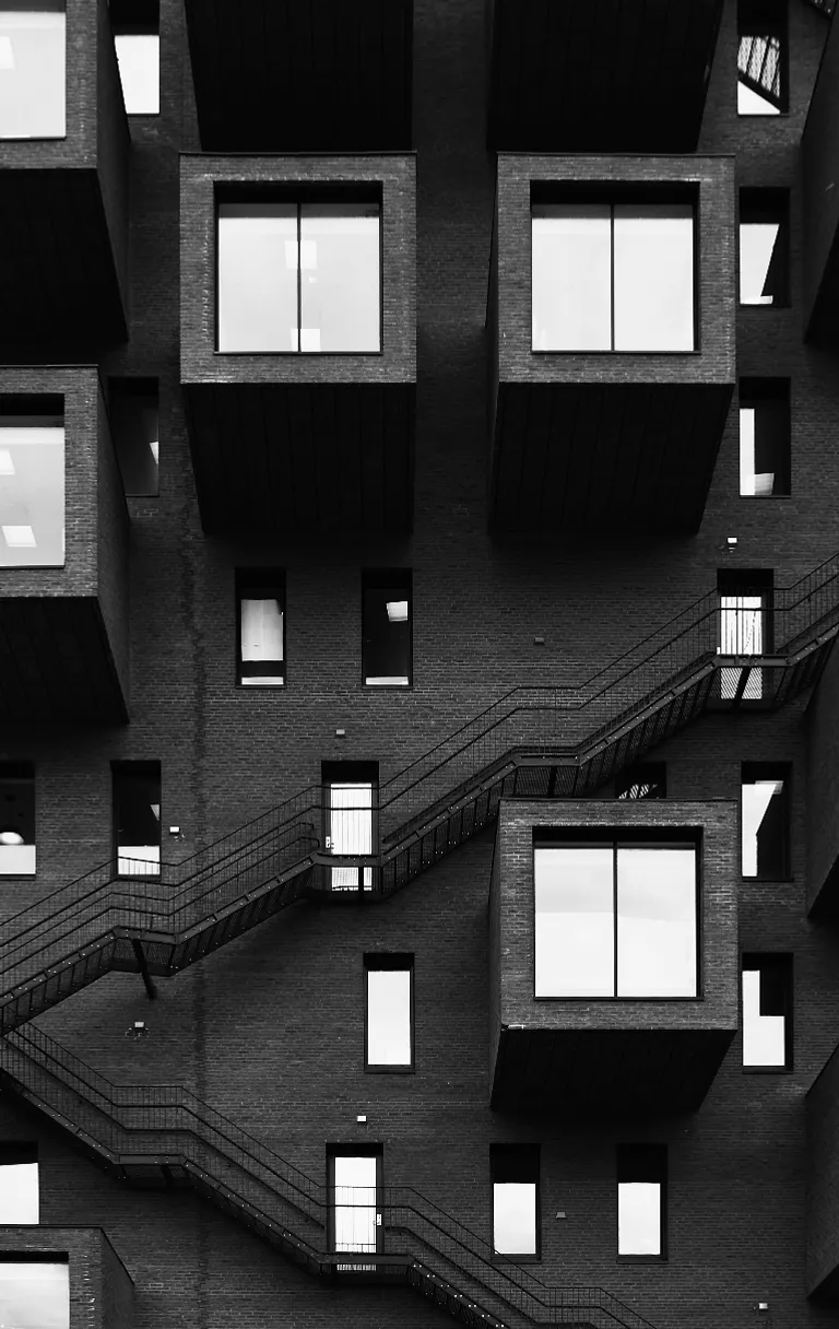 a black and white photo of a building with many windows