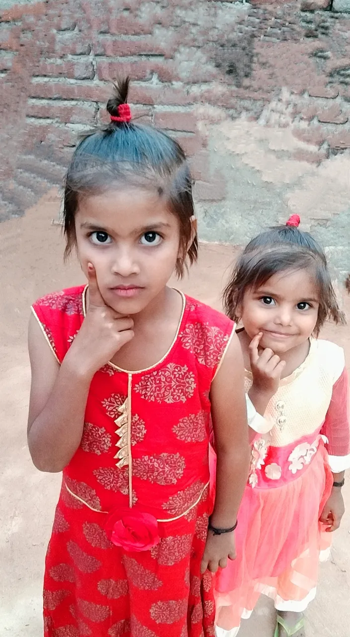 two little girls standing next to each other