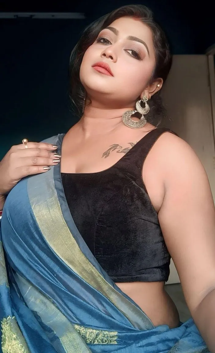 a woman in a black top and blue sari