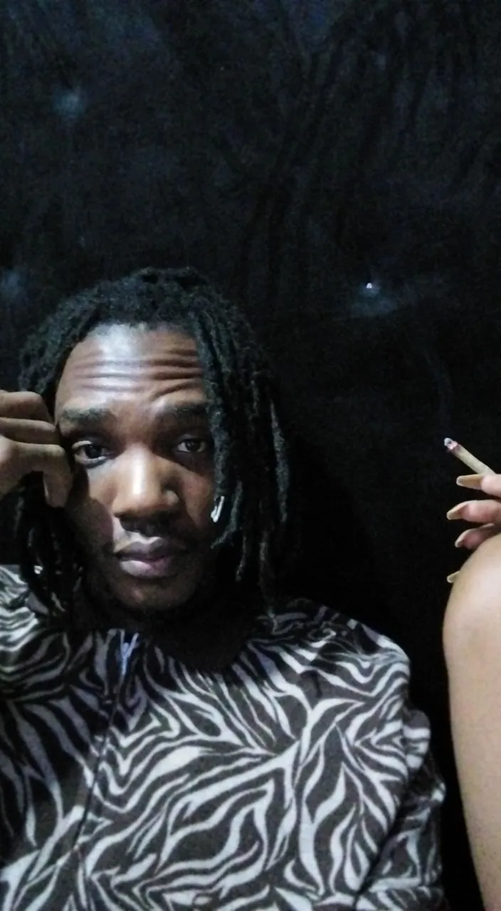 a man with dreadlocks sitting next to a woman