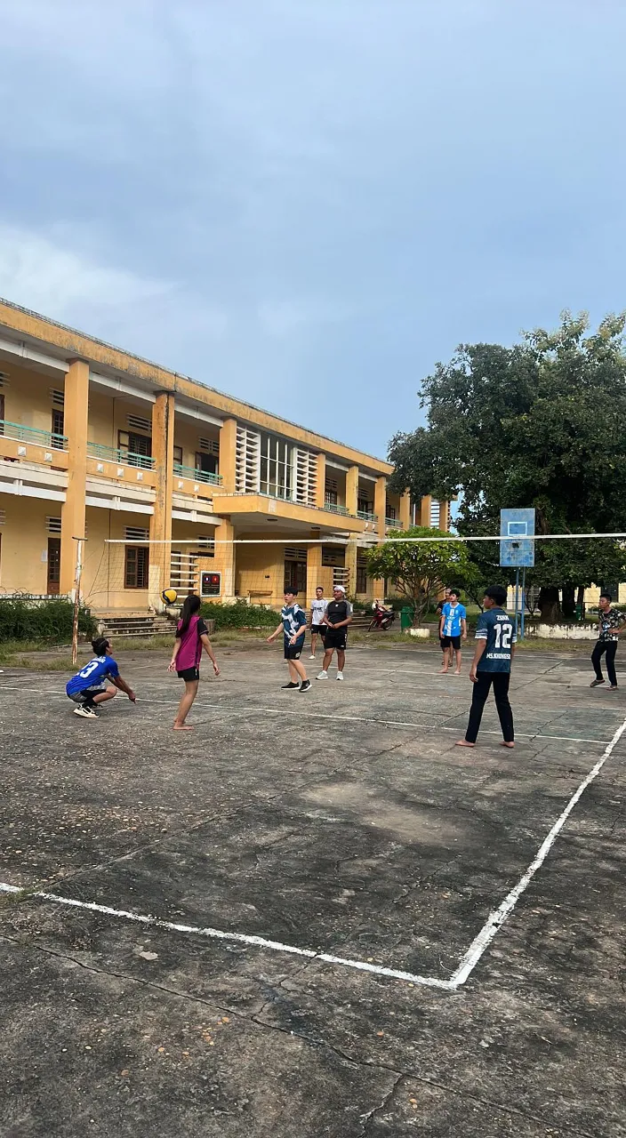 a group of people playing a game of volleyball