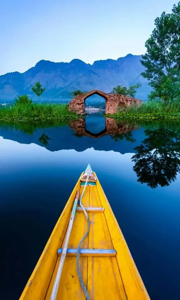 a yellow boat floating on top of a body of water