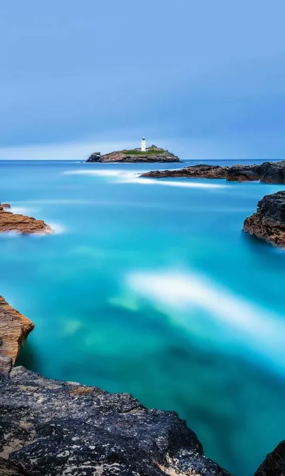 a body of water with a small island in the background