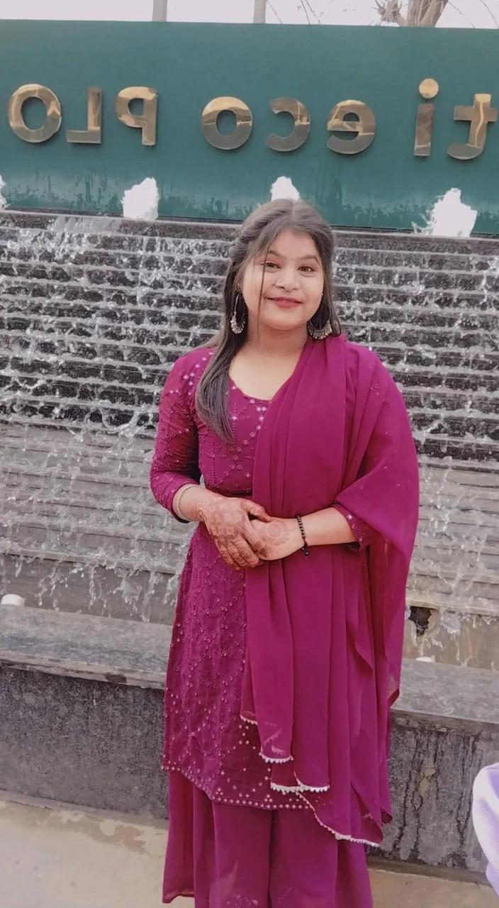 a woman standing in front of a fountain