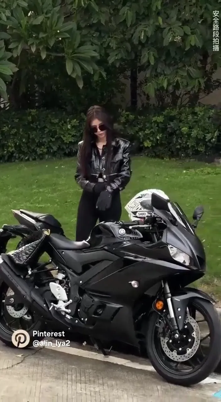 a woman riding  a black luxury motorcycle and wear black sunglasses video size 9.16 