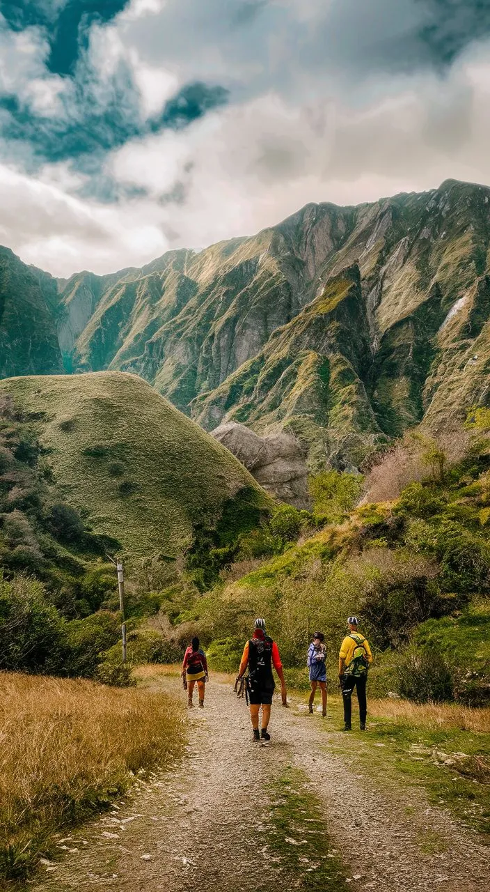 a group of people walking down a dirt road