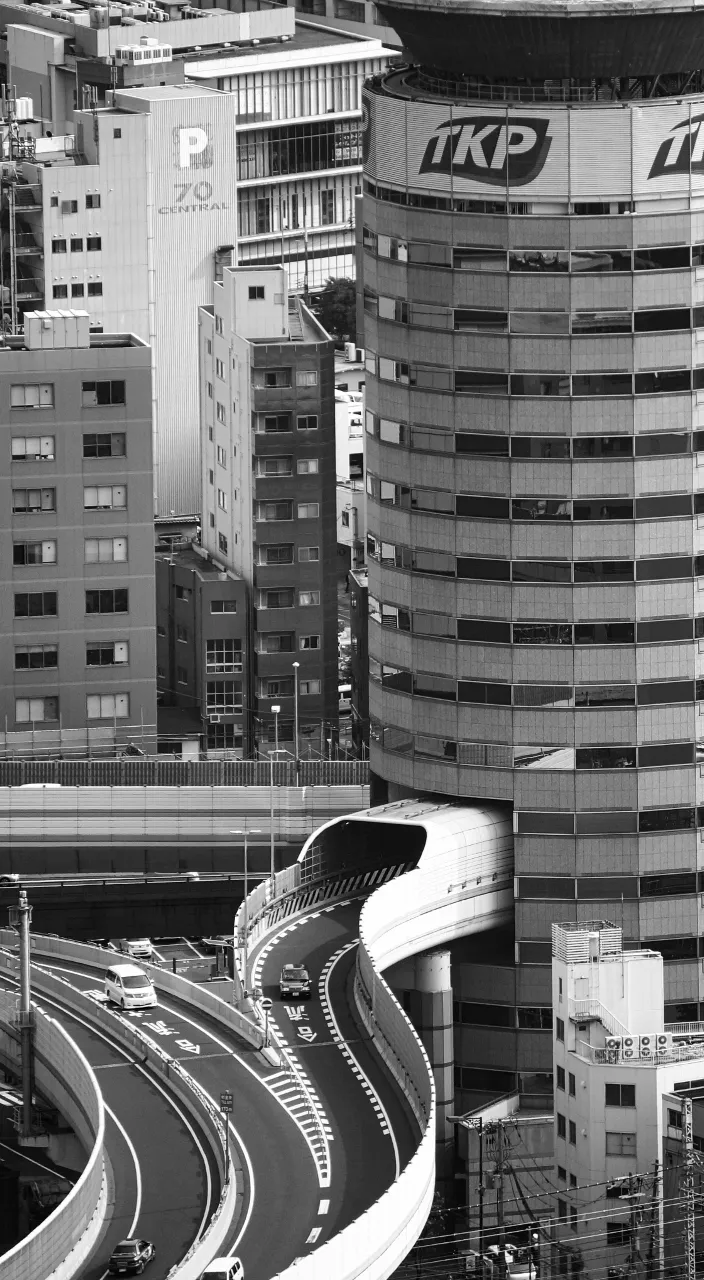 a black and white photo of a city in Osaka Japan